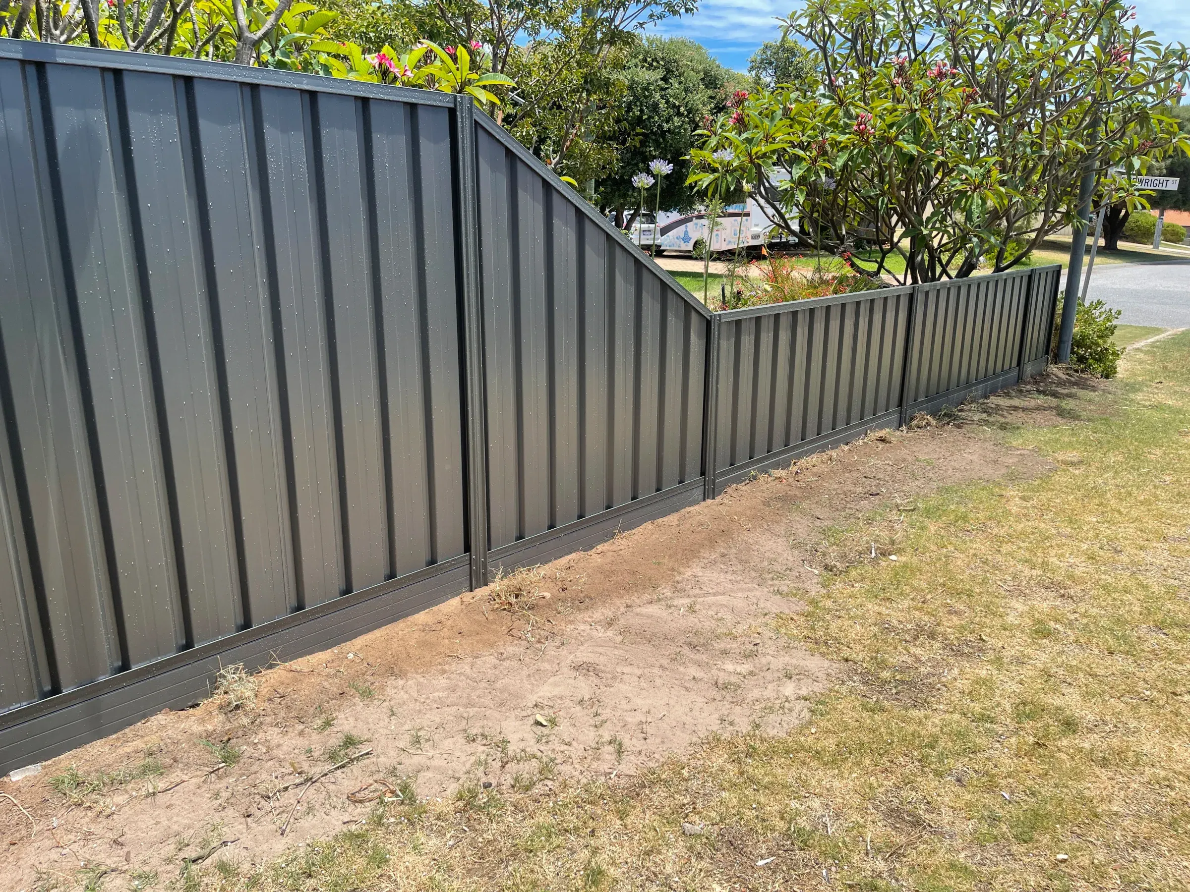 Grey Colorbond fence running along a street verge on a corner block