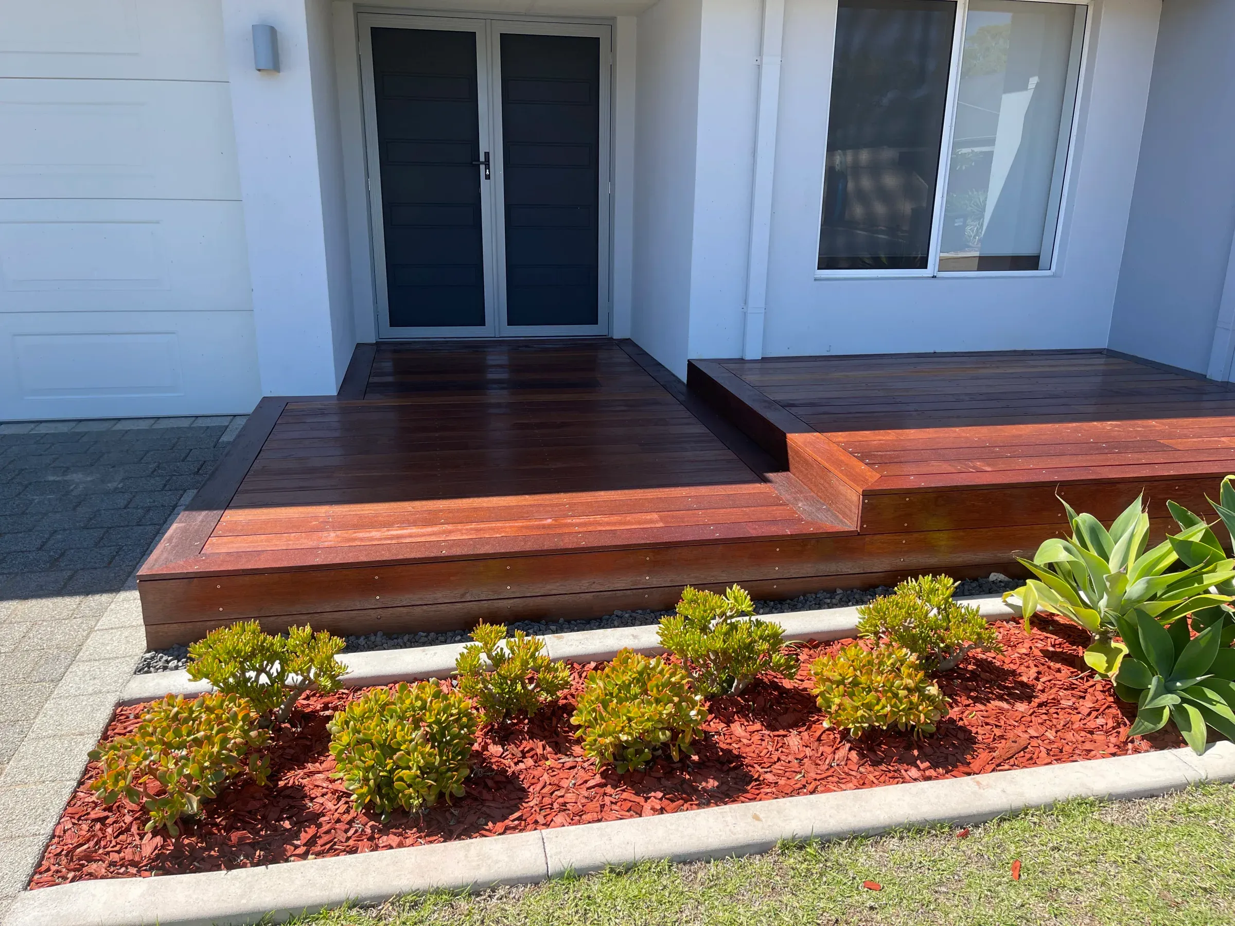 Jarrah entry deck with a broad step down to a mulched garden bed and planting
