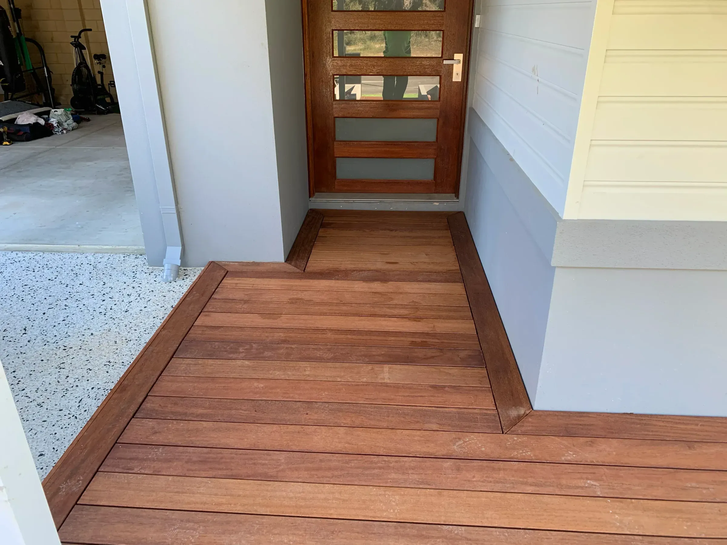Jarrah decked front entry leading to a timber front door